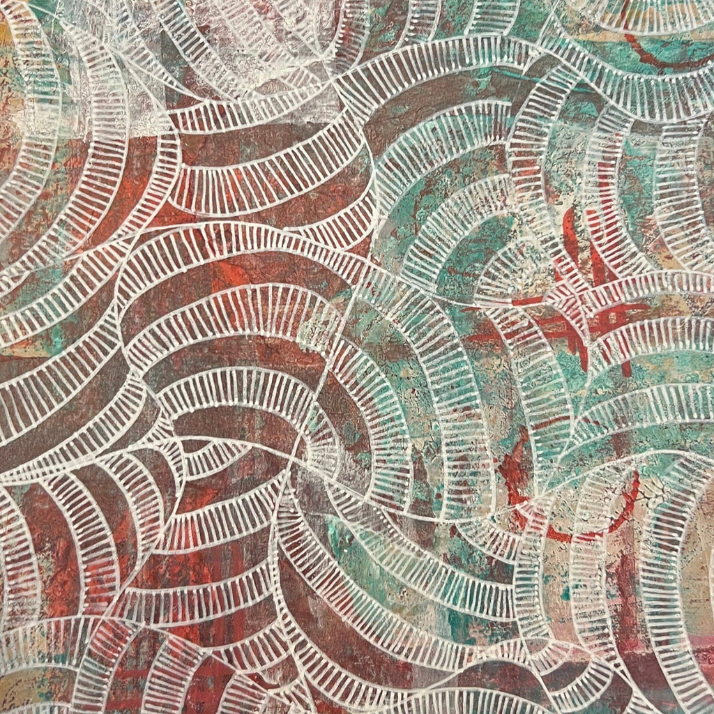 Hand holding a sheet of paper with a colorful abstract pattern