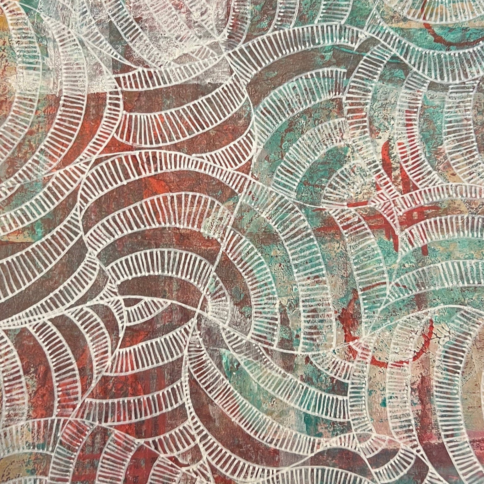 Hand holding a sheet of paper with a colorful abstract pattern